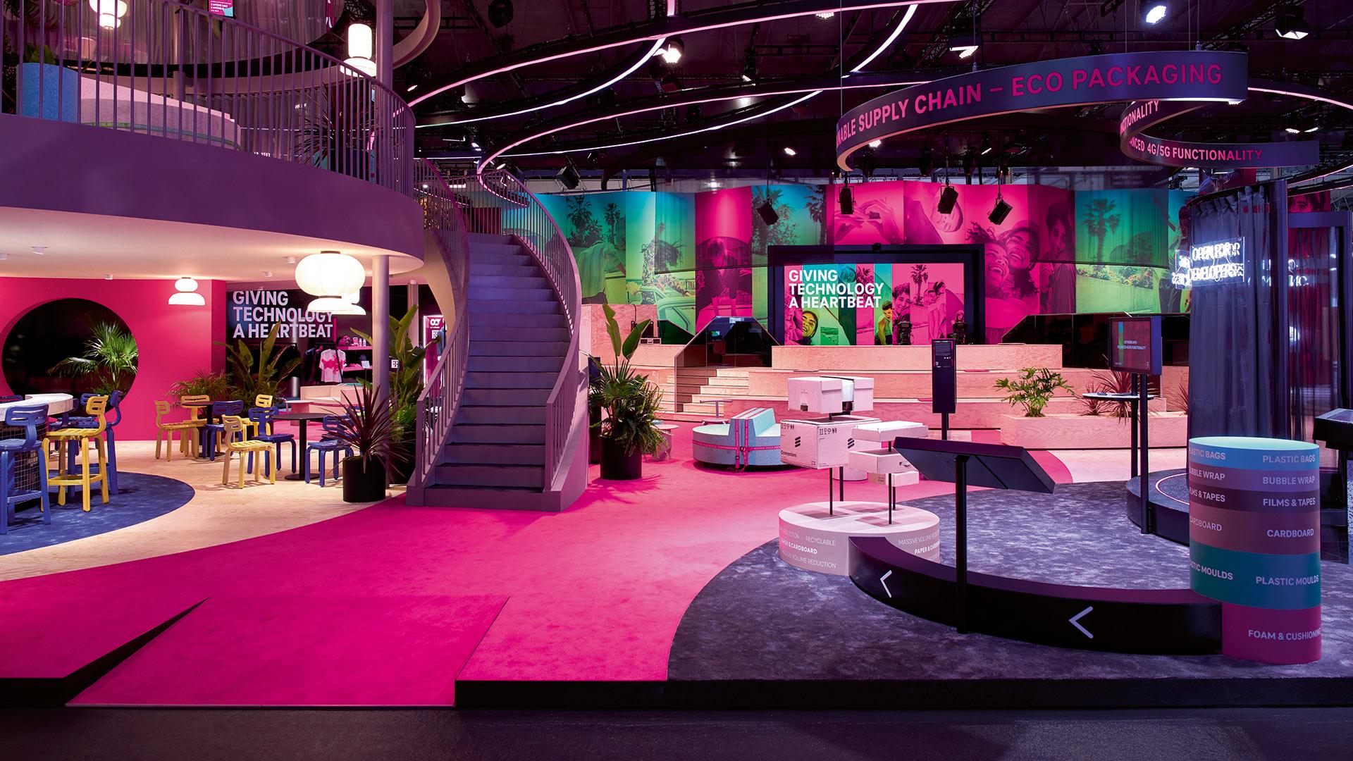 MWC 2023, Deutsche Telekom. Side antrance showing the hospitality area on left side and on the right side topic of Sustainable Packaging, ensuring the move towards a sustainable supply chain.
